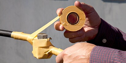 Image of 3M™ Scotch® Rubber Mastic Tape 2228 wrapping a medium voltage cable in a manhole.
