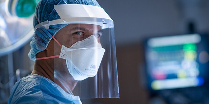 Clinician wearing a filtering facepiece respirator and faceshield

