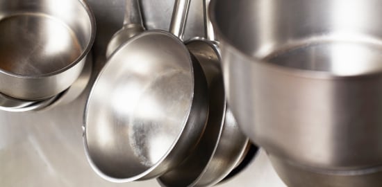 A man washing dishes in a commercial kitchen
