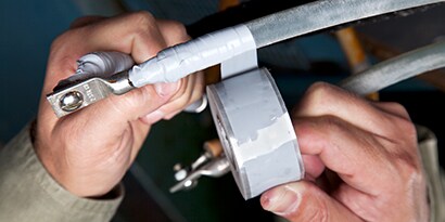 Image of 3M™ Scotchfil™ Electrical Insulation Putty applied over split bolt wrapped with Scotch® Self-Fusing Silicone Rubber Tape 70 HDT.
