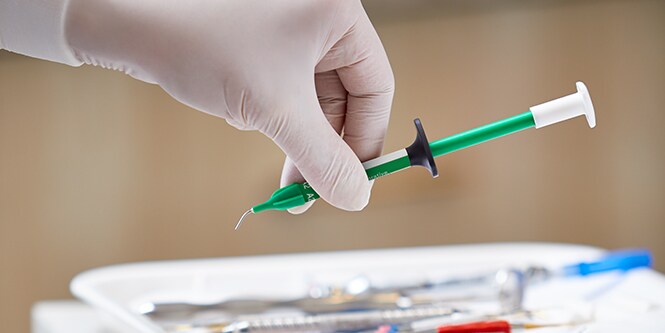 close up of hand pinking up syringe
