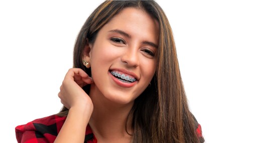 A smiling girl, wearing braces.
